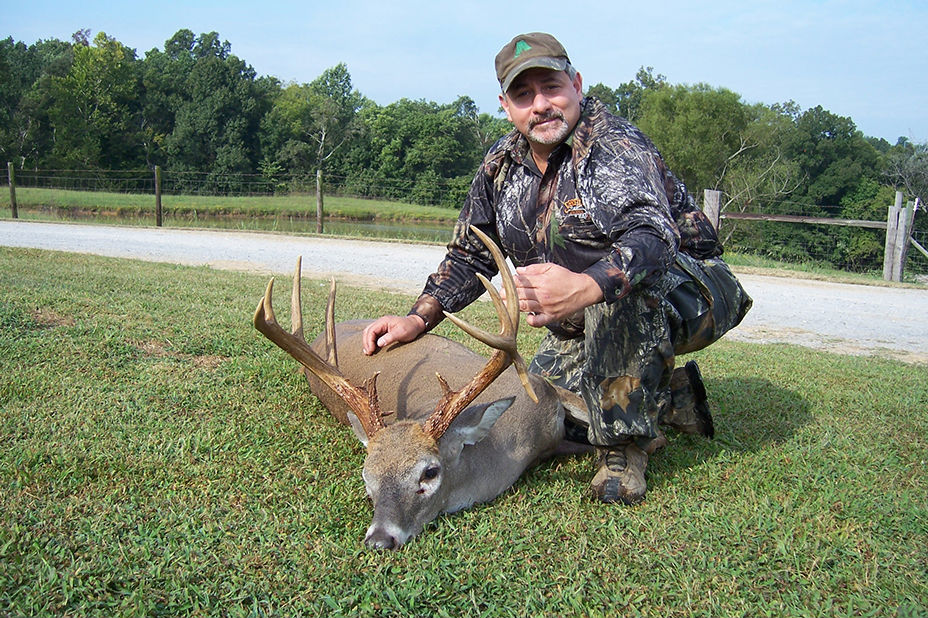 A hunter with his deer at Long Creek Outifitters