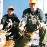 Two men pose with their deer at Long Creek Outfitters