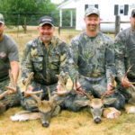 A group of men pose with their deer at Long Creek Outfitters